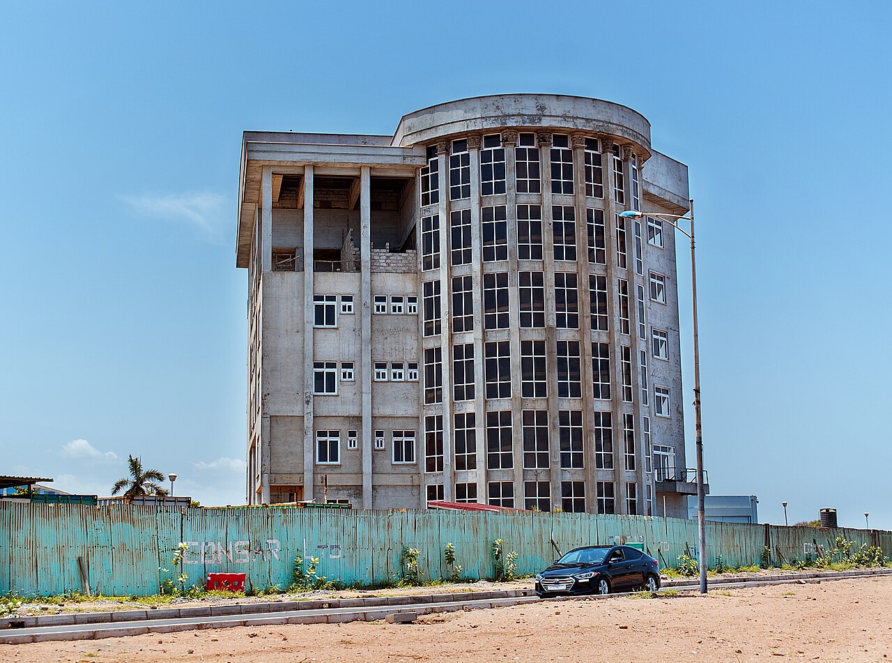 Construction workers and building materials at a site in Ghana reflecting rising building inflation.