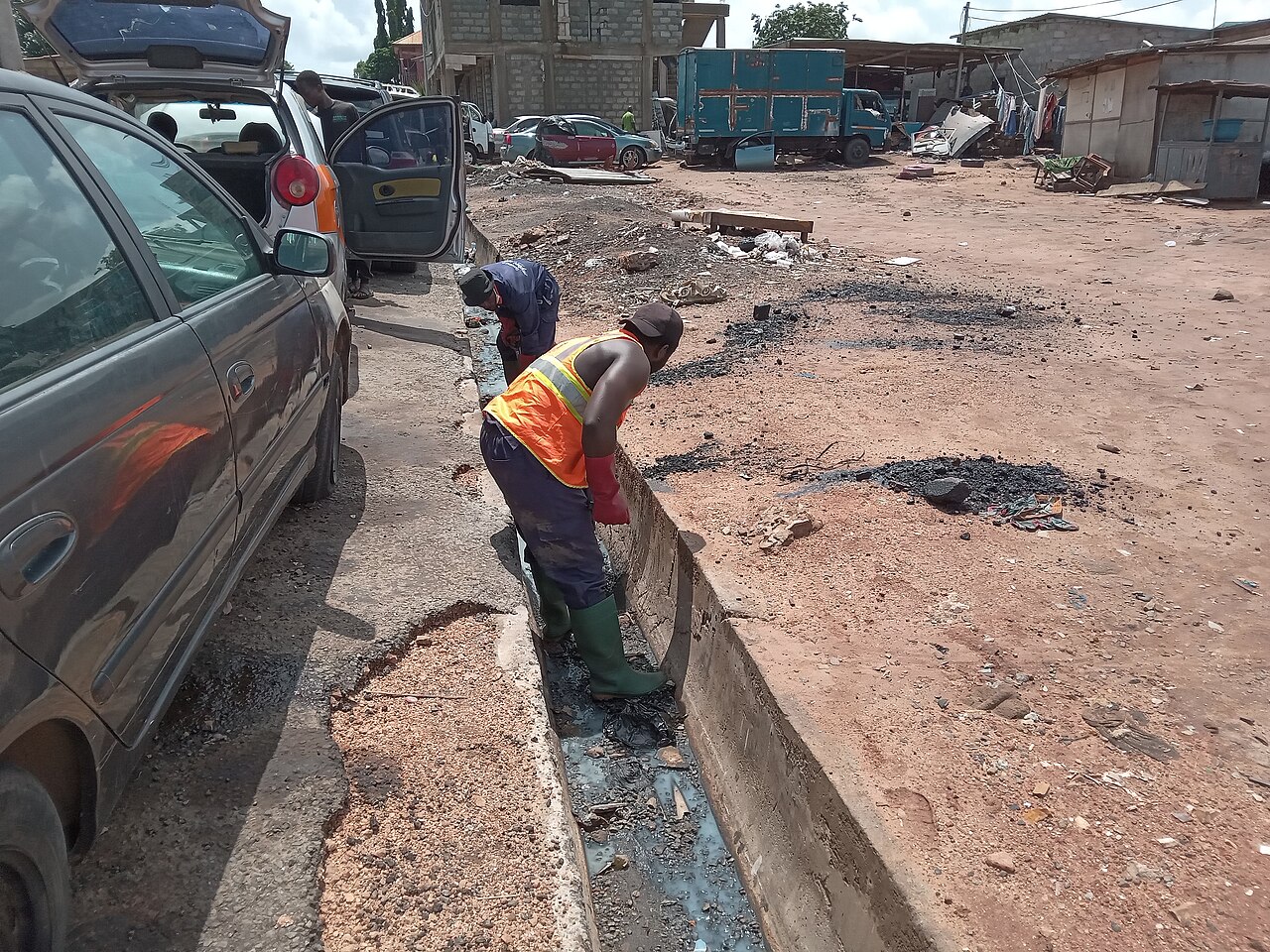 Volunteers participating in a community sanitation and cleanup exercise in Ghana