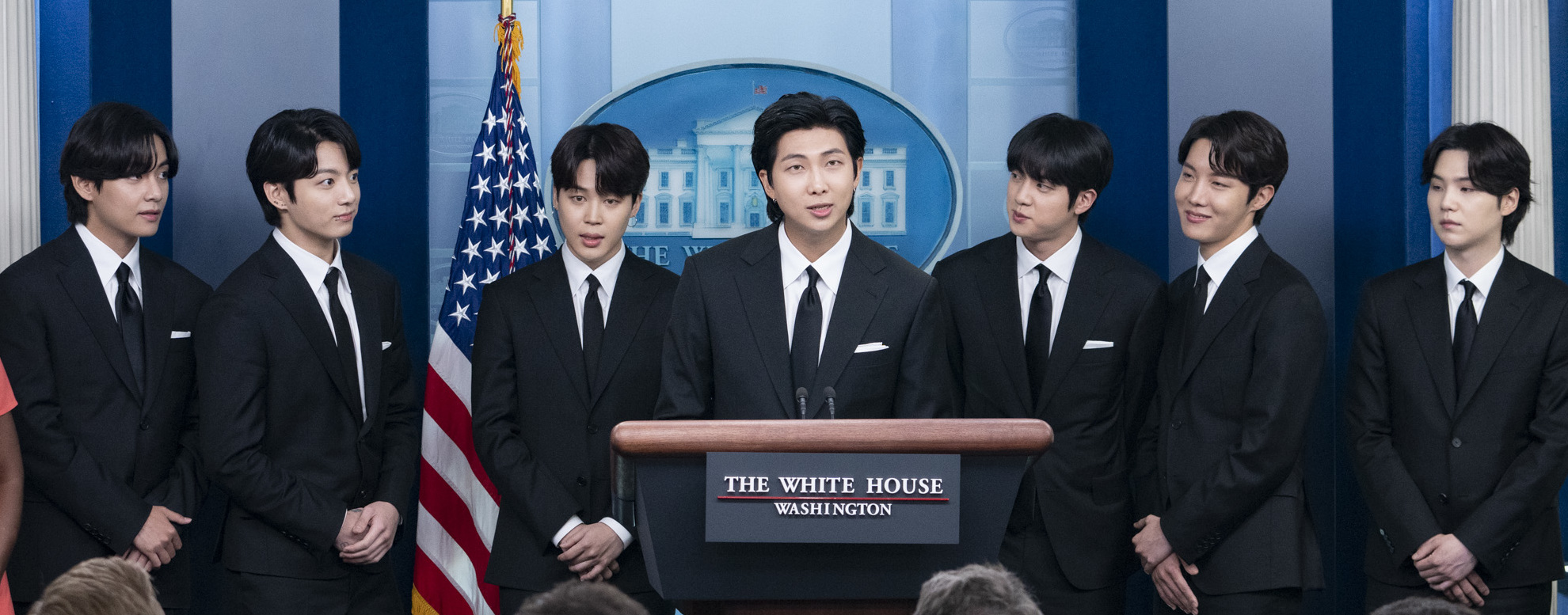 BTS performing on stage at a global stadium concert