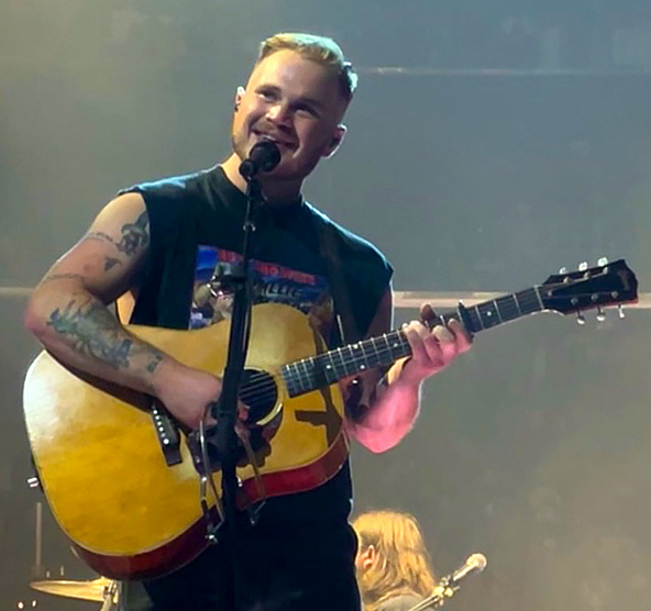 Country music singer-songwriter Zach Bryan performing live on stage
